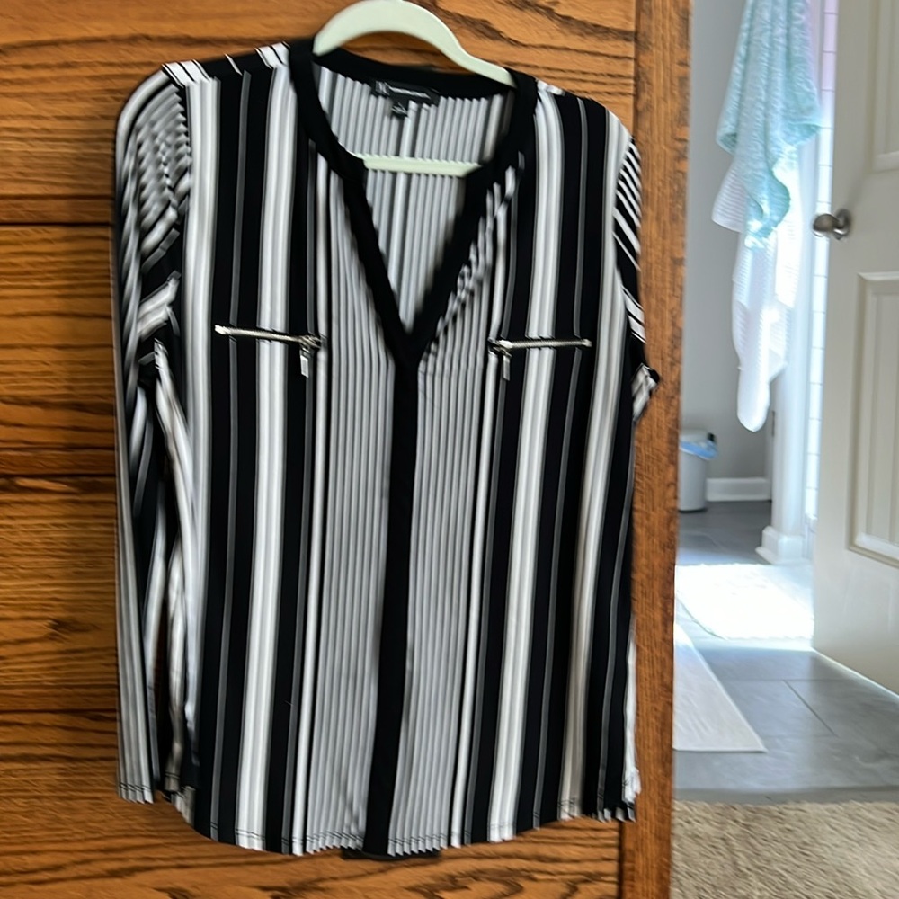 This blouse was bought at Macy’s. It is a large and 95% polyester 5% spandex